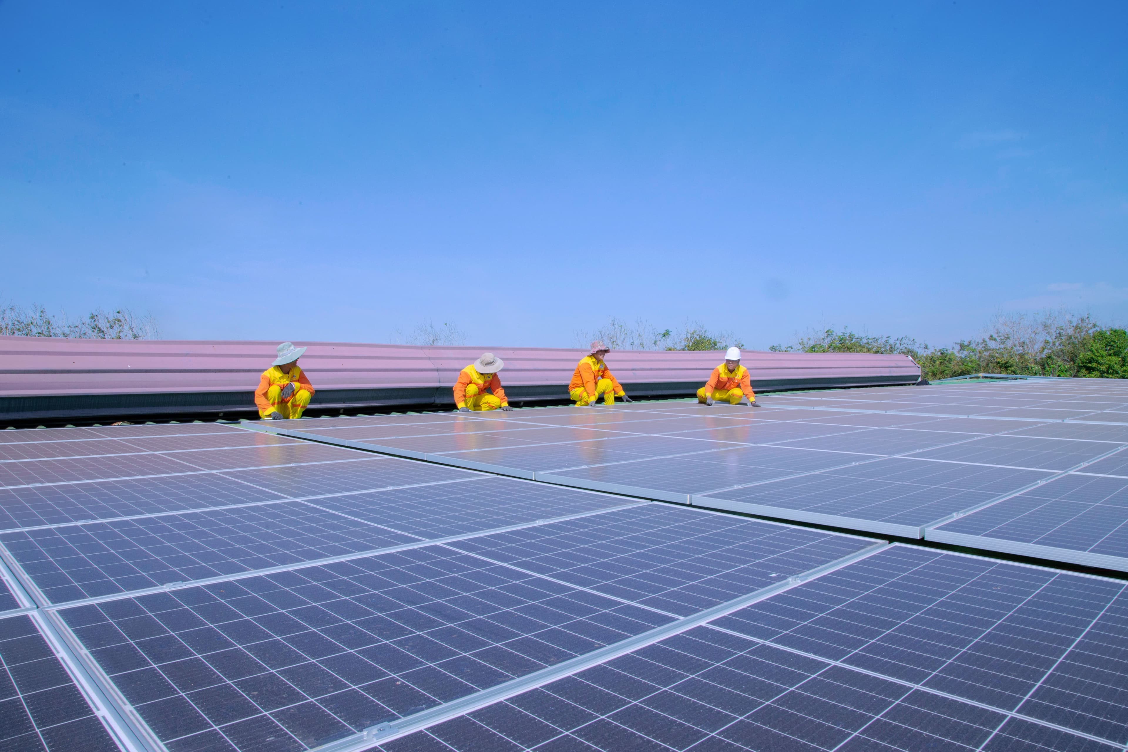 Engineering team installing a large commercial rooftop solar array