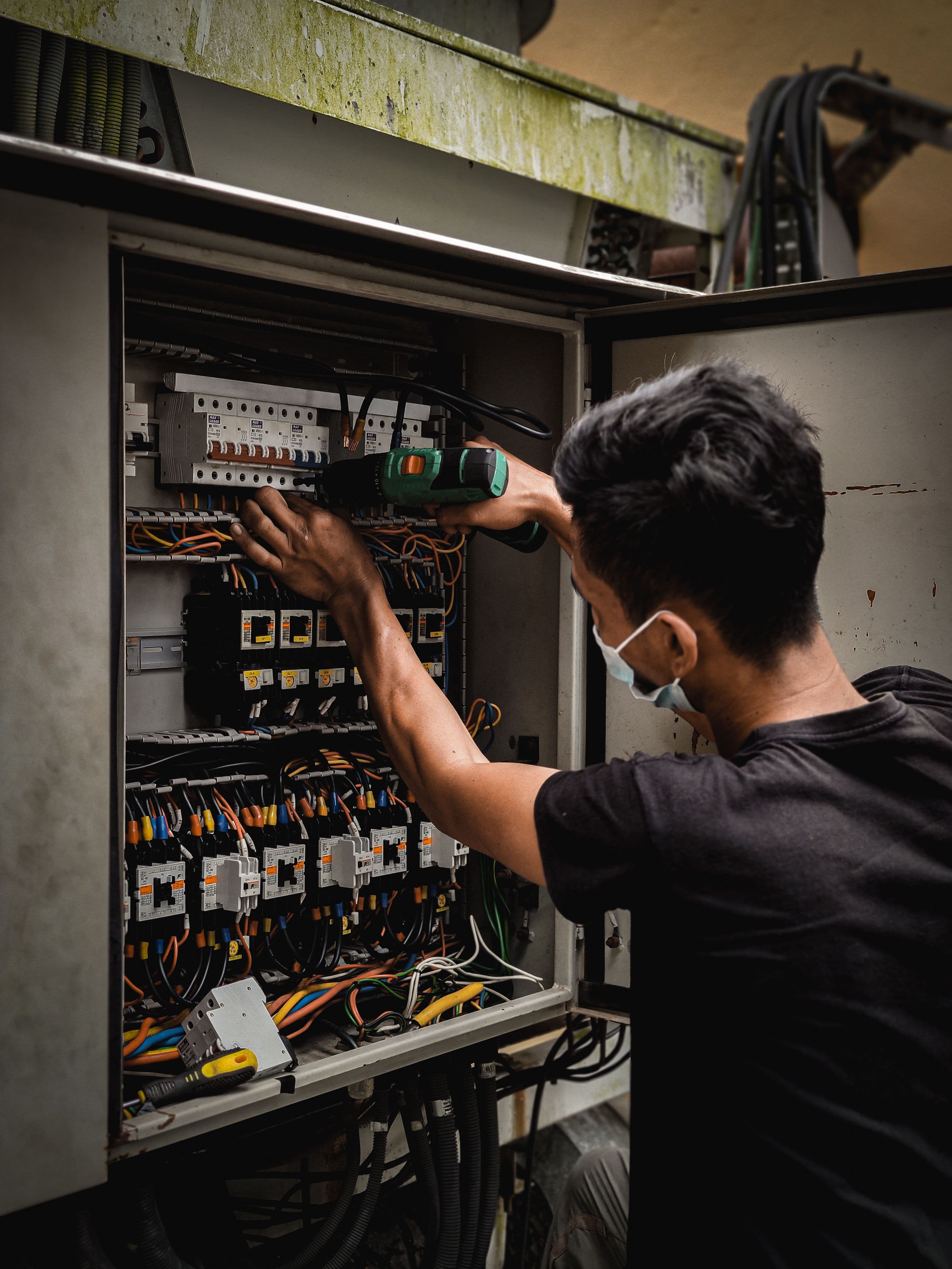 Electrical engineer commissioning an industrial control and distribution panel